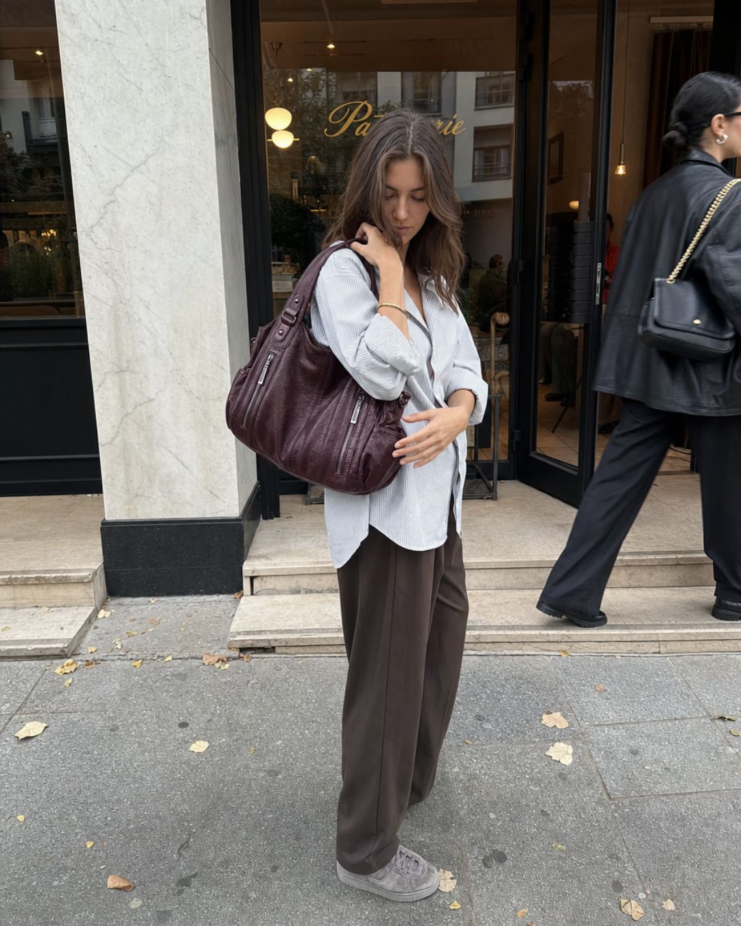 The Burgundy Brooklyn Bag worn outside a café